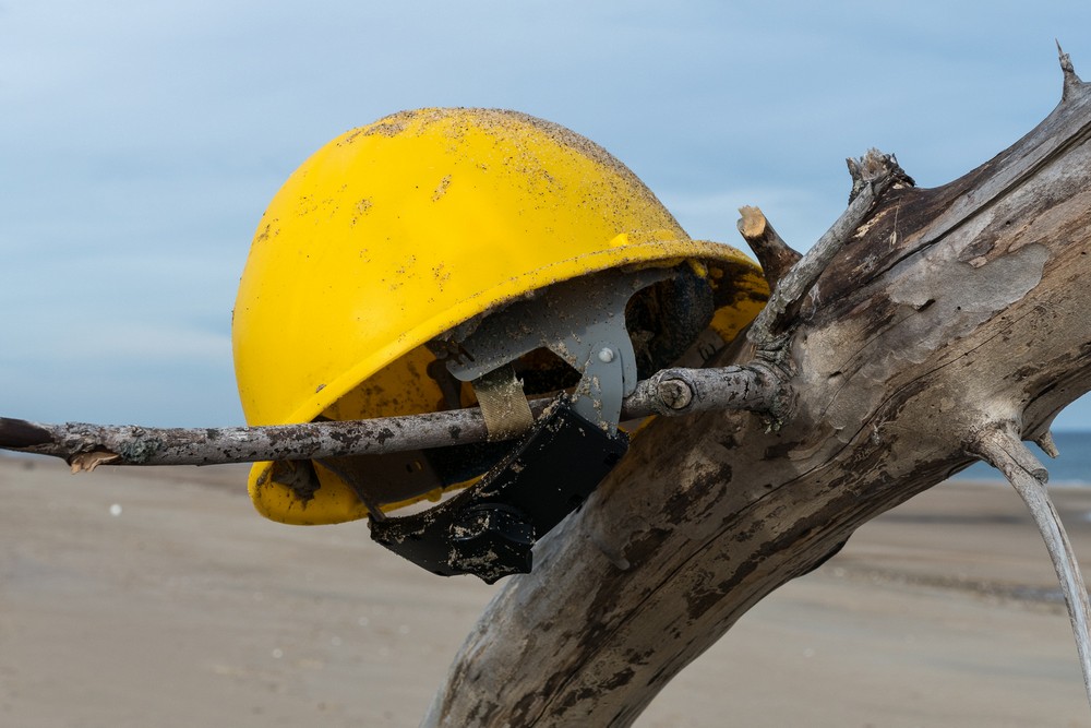 A bright yellow hard hat placed on driftwood.<br />A second day at Plum Island on a balmy (50 degree) day.<br />Jan. 11, 2018 - Parker River National Wildlife <br />Refuge, Plum Island, Massachusetts.