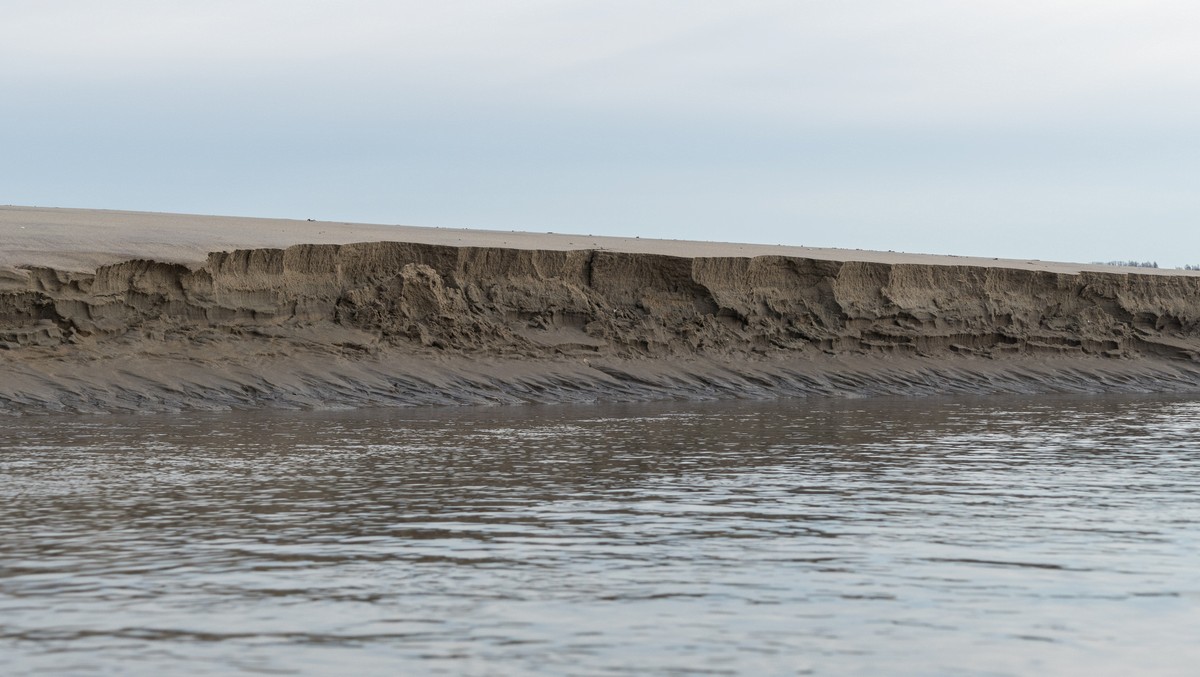 Cliff (~2 feet high) along exit channel of tidal pool.<br />March 1, 2018 - Sandy Point State Reservation, Plum Island, Massachusetts.