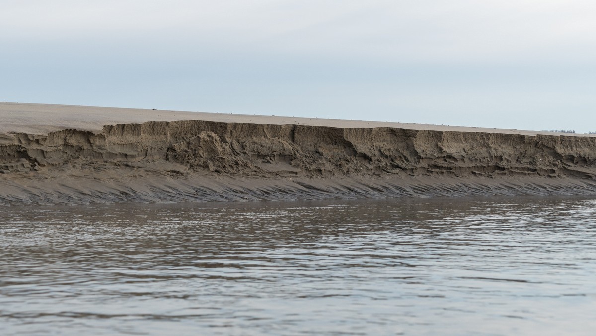 Cliff (~2 feet high) along exit channel of tidal pool.<br />March 1, 2018 - Sandy Point State Reservation, Plum Island, Massachusetts.