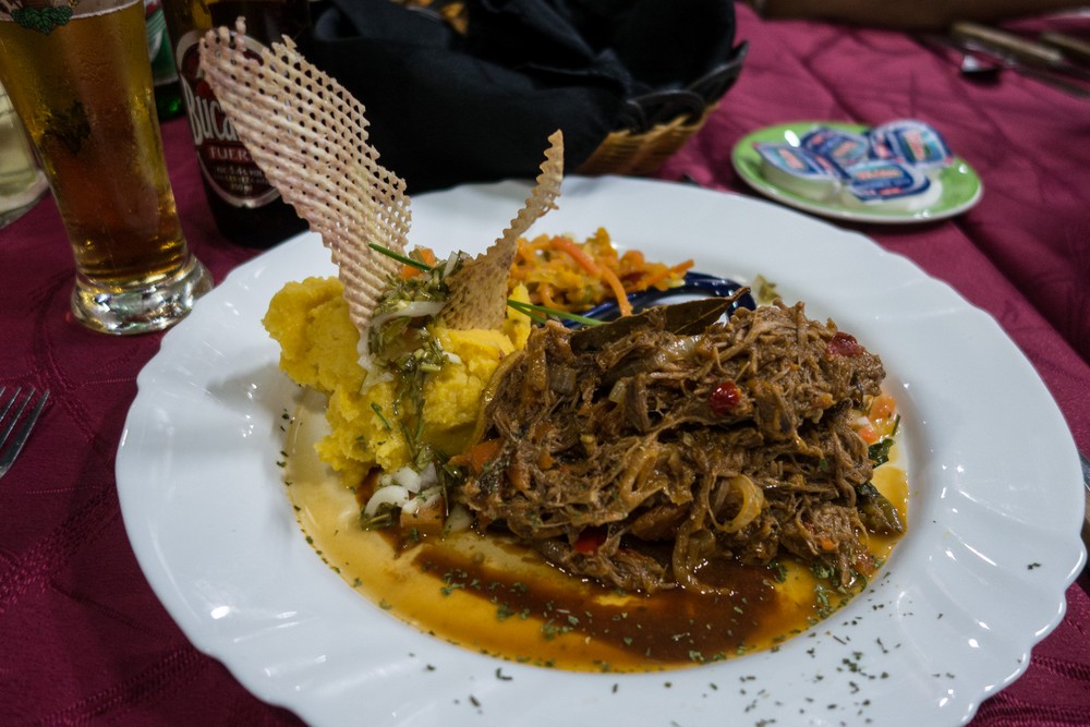 My ropa vieja (old clothes - shredded beef) dinner was very tasty and went well with some Bucanero beer.<br />Dinner at the St. Pauli Restaurant.<br />Oct 31, 2016 - Santiago de Cuba.