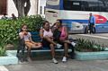 Girl and two women using the local WiFi hot spot.<br />Nov. 2, 2016 - Parque Cespedes, Bayamo, Cuba.