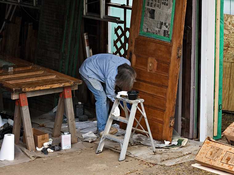 May 9, 2008 - Merrimac, Massachusetts.<br />Joyce stripping the paint off old doors to be used for her studio.