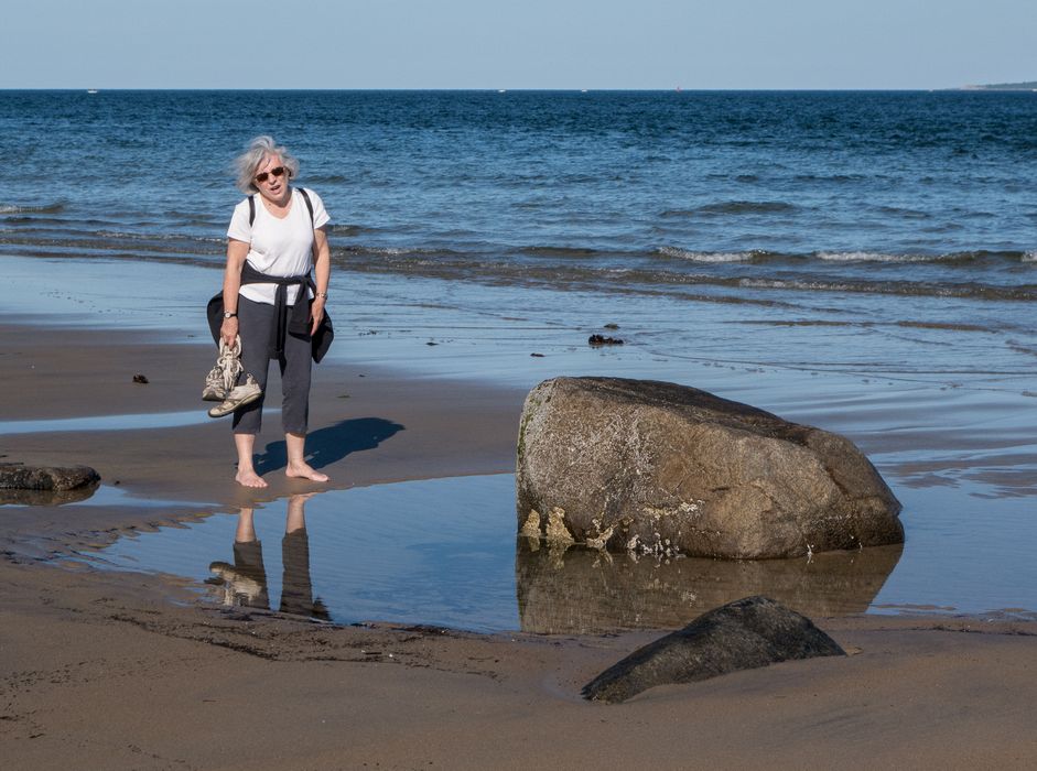 Joyce at rock in puddle on beach.<br />une 16, 2014 - Sandy Point State Reservation, Plum Island, Massachusetts.
